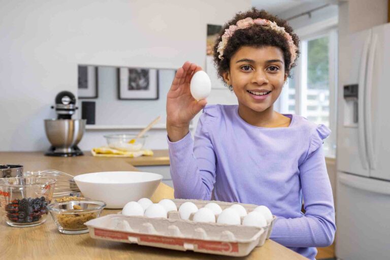 a girl holding an egg