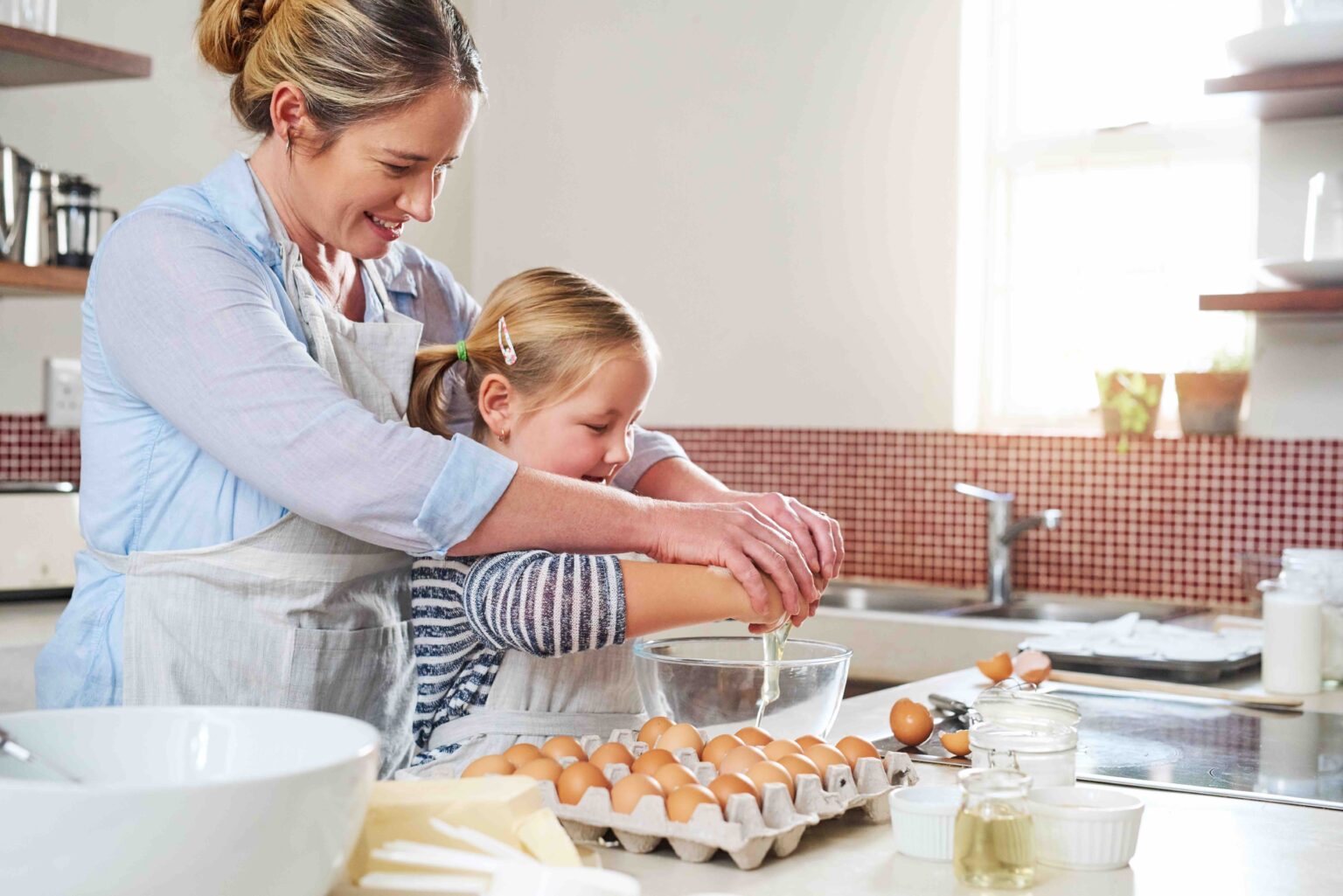 a woman and a girl making food