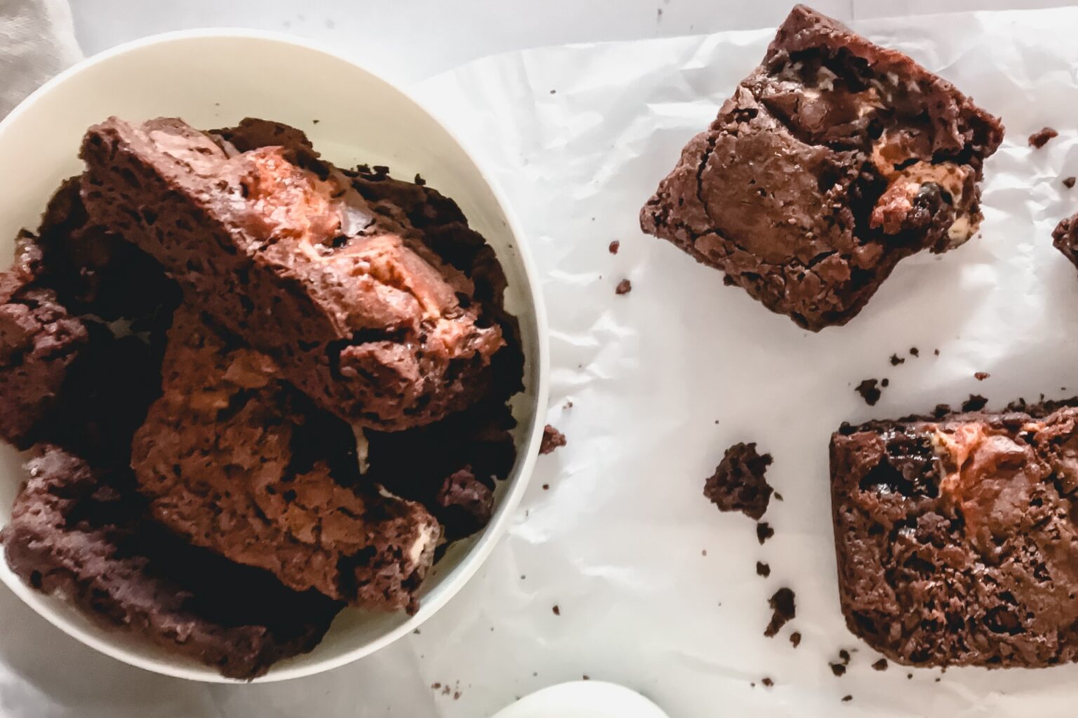 a bowl of brownies on a white surface