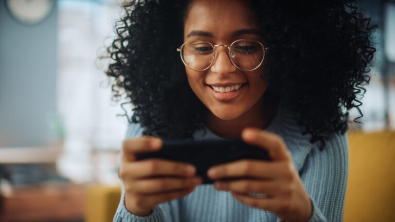 Black woman playing free phone games on a device