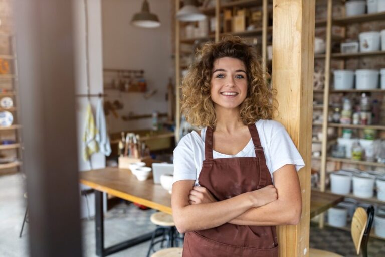 a woman in a brown apron leaning against a wooden post