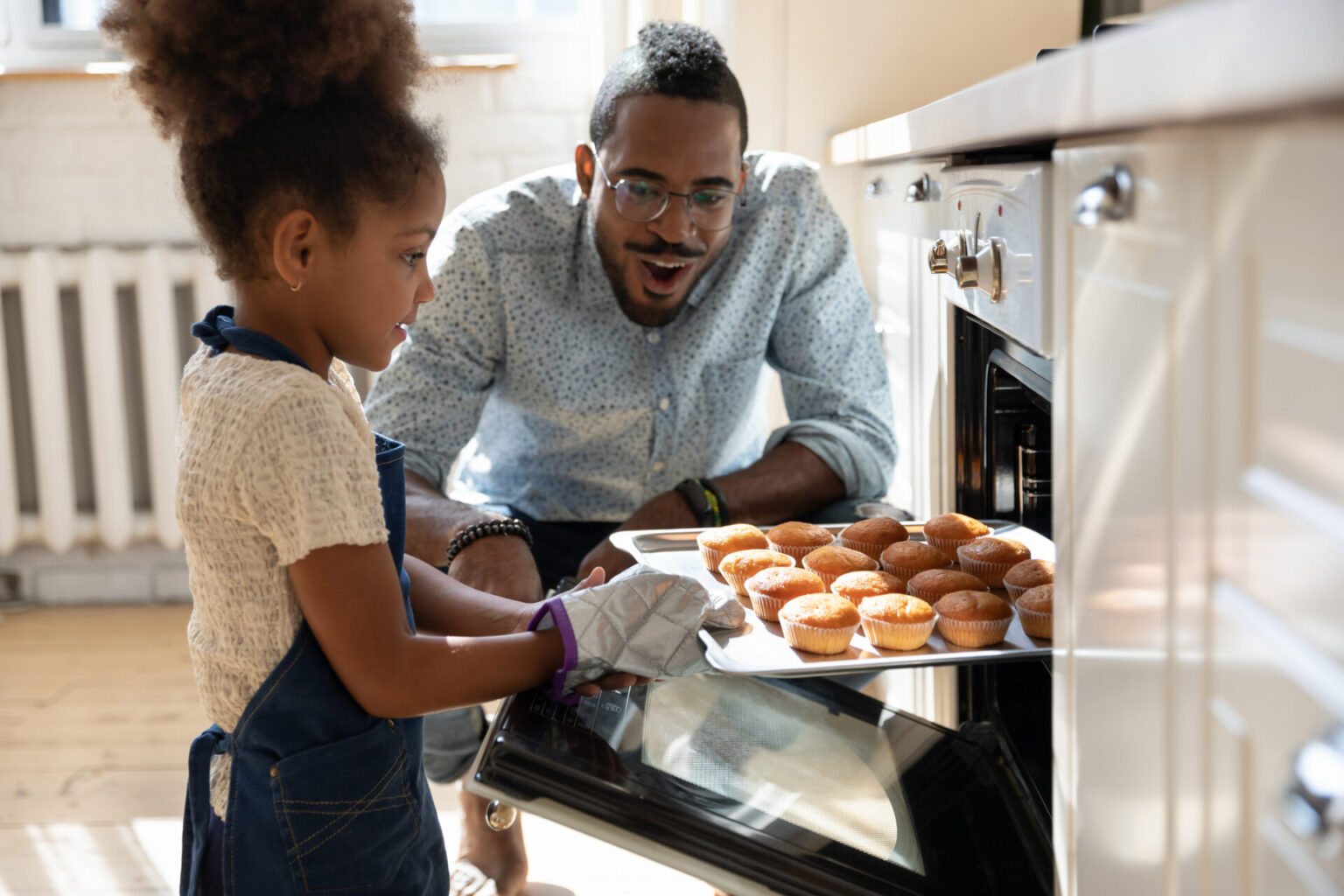 dad and daughter baking muffiins