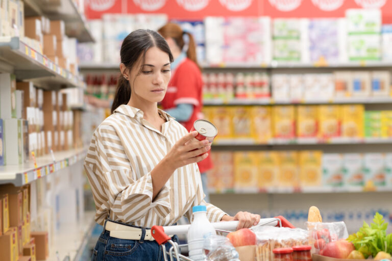 Understanding Canada's New Food Labeling Requirements, woman reading a nutrition label in store