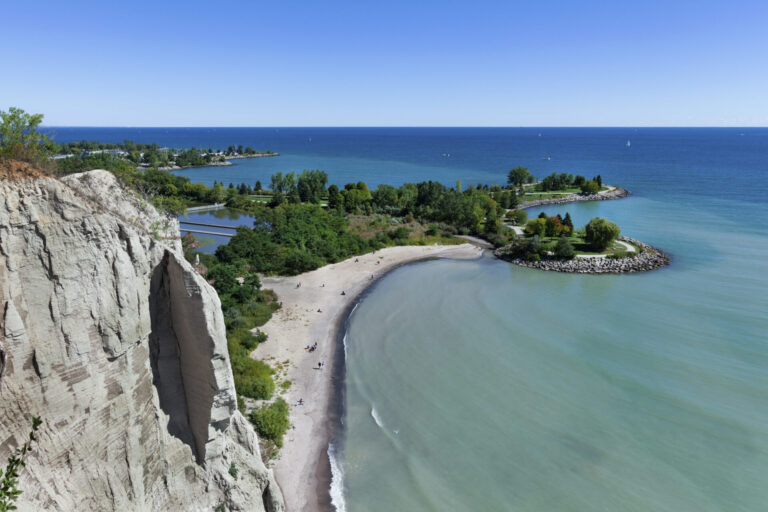 A photo of a Torontonian's favourite spot in the city: Bluffer's Park and Beach, a limestone cliffside beach with cerulean blue water off Lake Ontario.