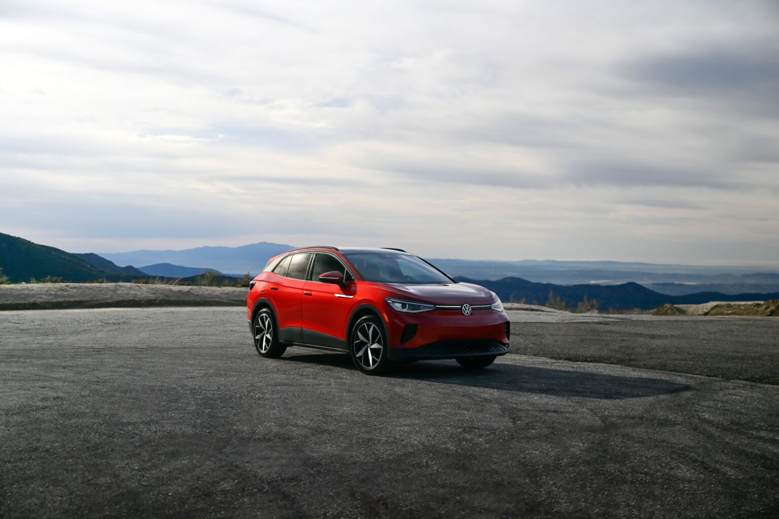 The Volkswagon ID.4 in red sits in a vast lot