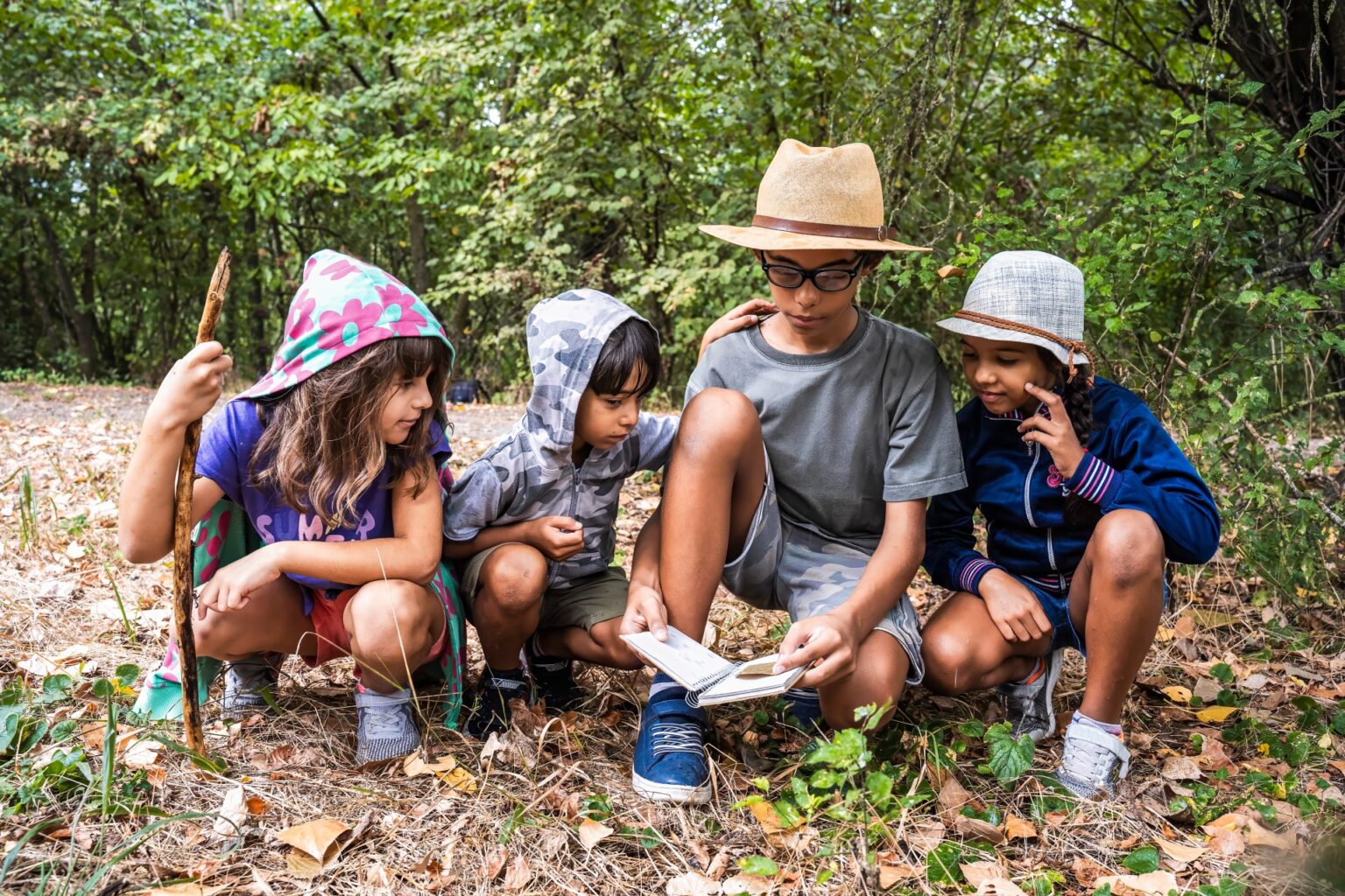 Kids at summer camp gather around to investigate nature