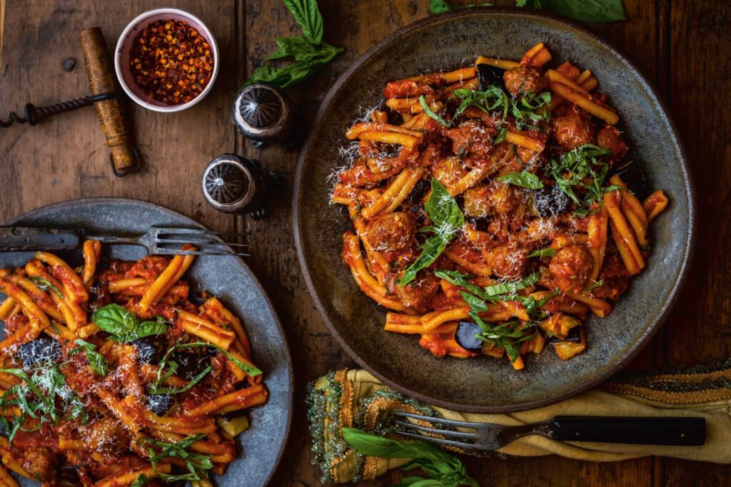 plates of pasta with a rich tomatoey sauce