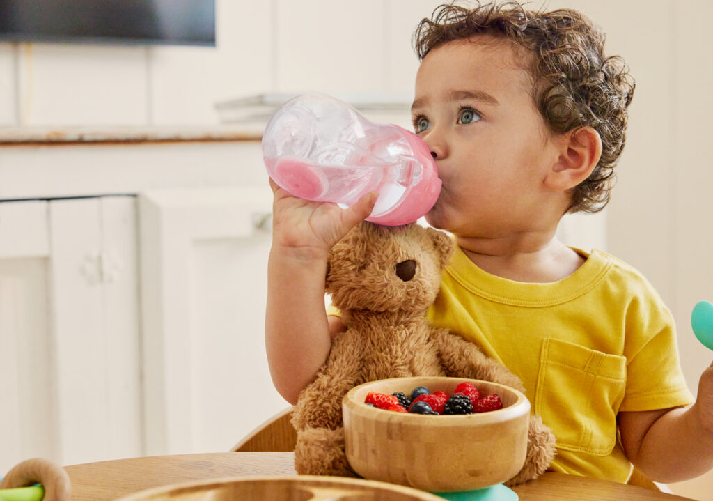 toddler drinking from sippy cup