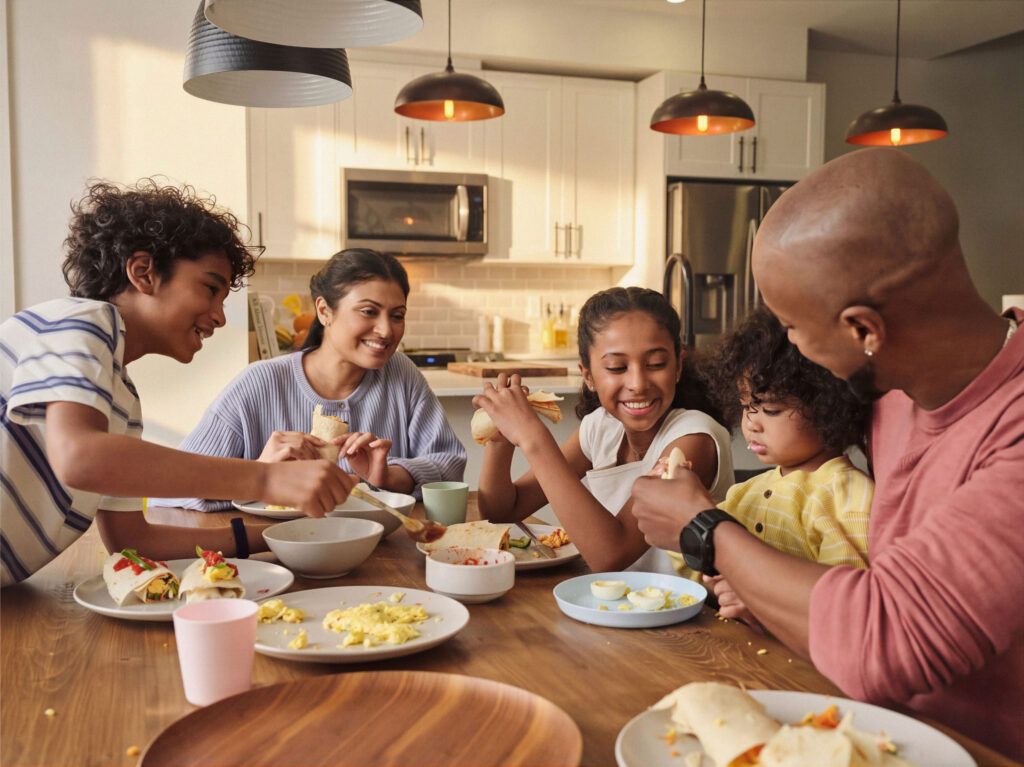 Family eating egg burritos for dinner