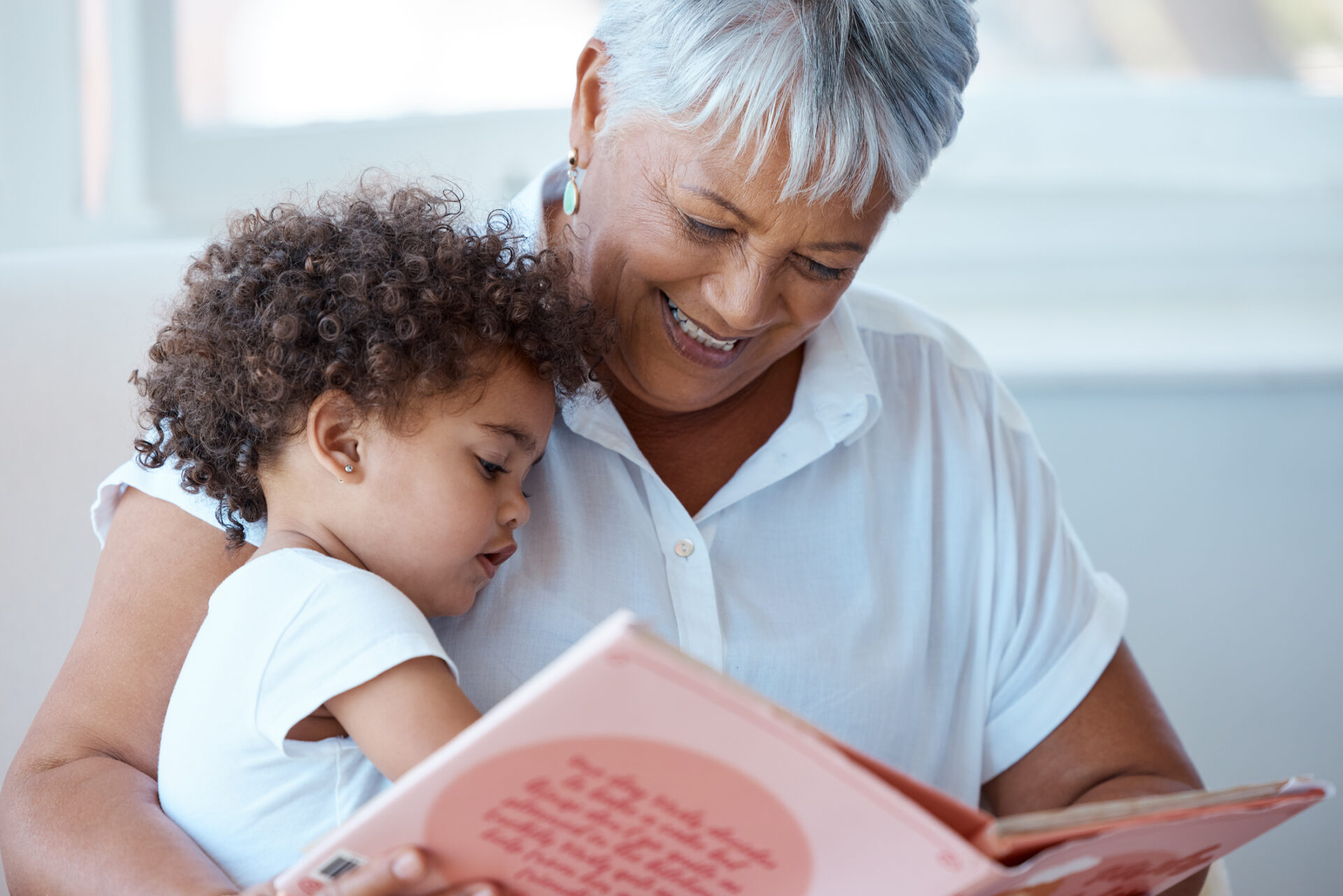 Grandmother reading to her grandchild, to illustrate skipping some problematic children's books