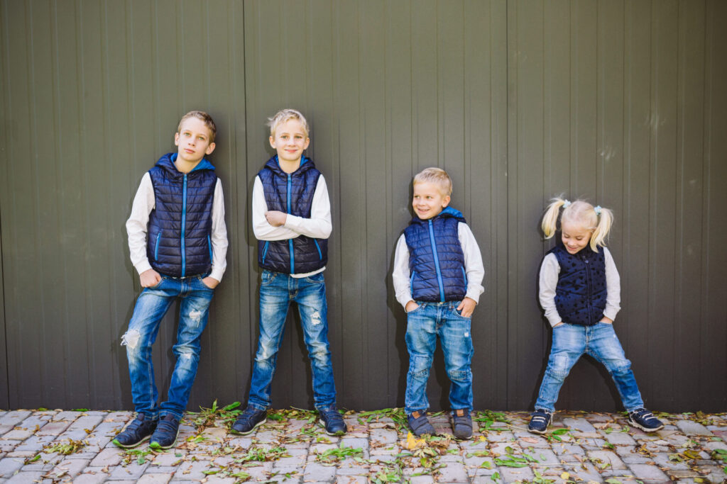 Three brothers and a sister in a row to illustrate sibling order theory