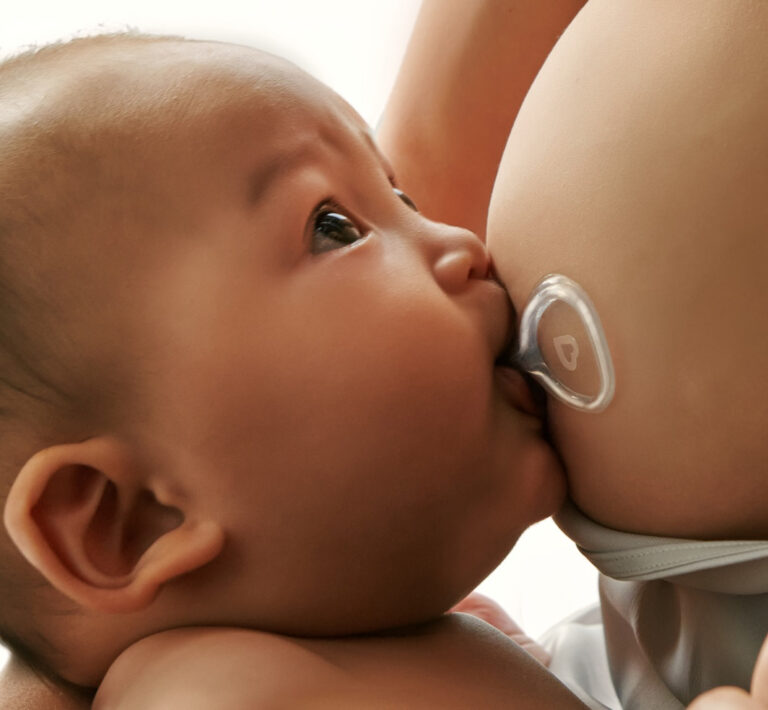 baby breastfeeding with nipple shield