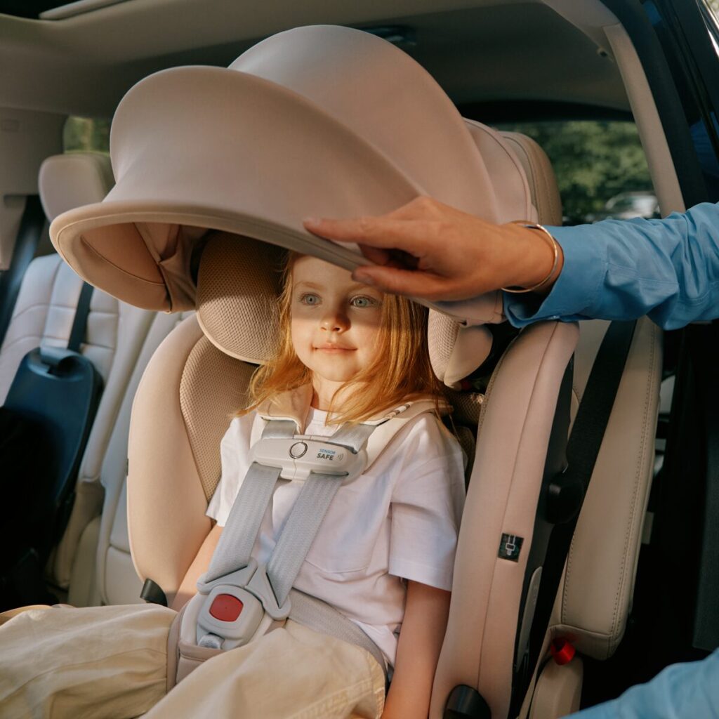 Toddler sitting in a forward facing Cybex Callisto G 360 Car seat with the canopy down