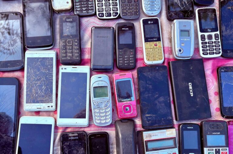 Old electronics on a pink background