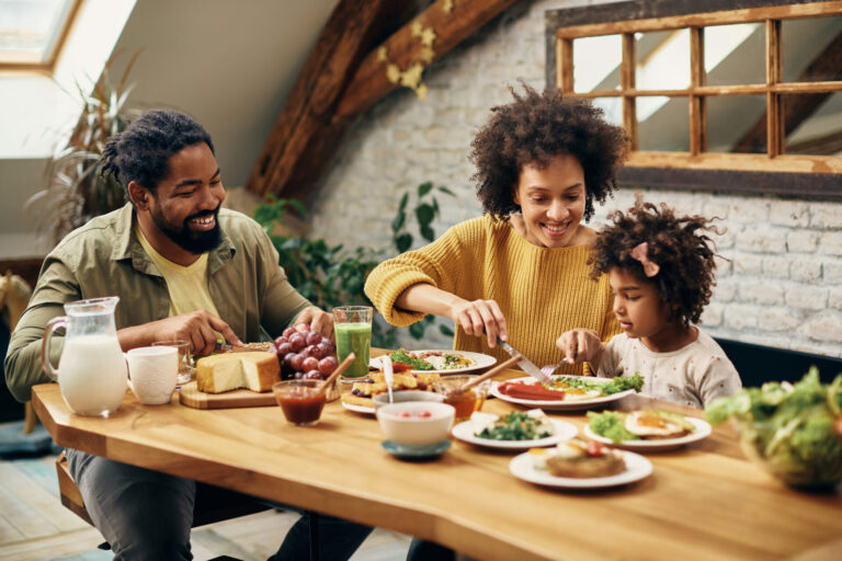 Family sitting at the table eating a deconstructed dinner