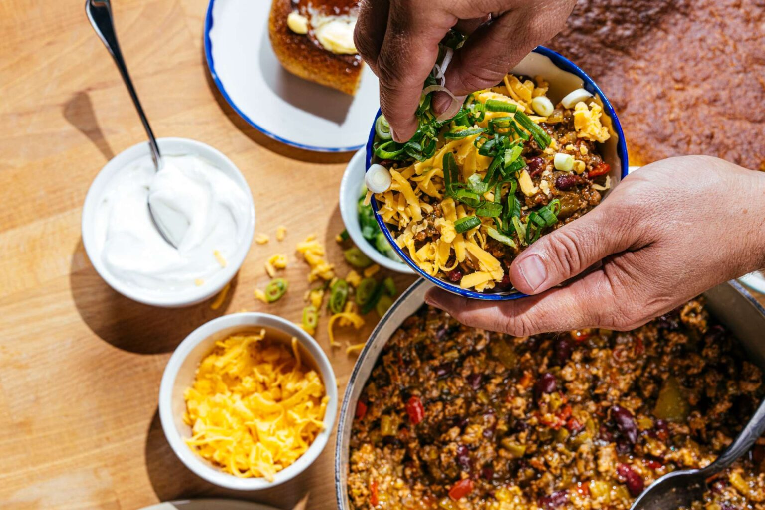 Bowl of turkey chili with lots of toppings