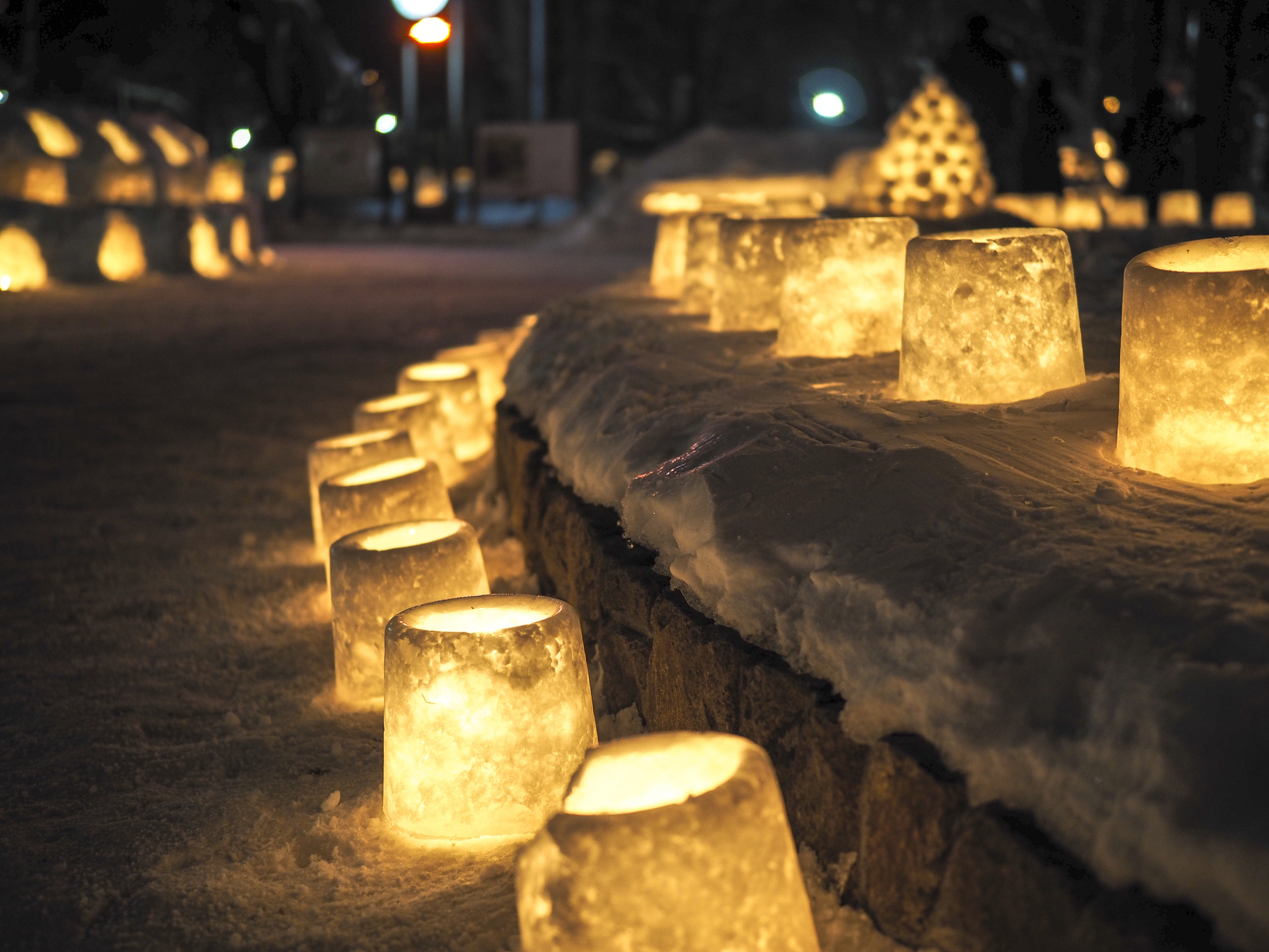 DIY ice lanterns lining a snowy street