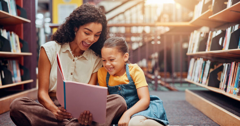Mom and daughter reading in a library, to show how libraries are evolving