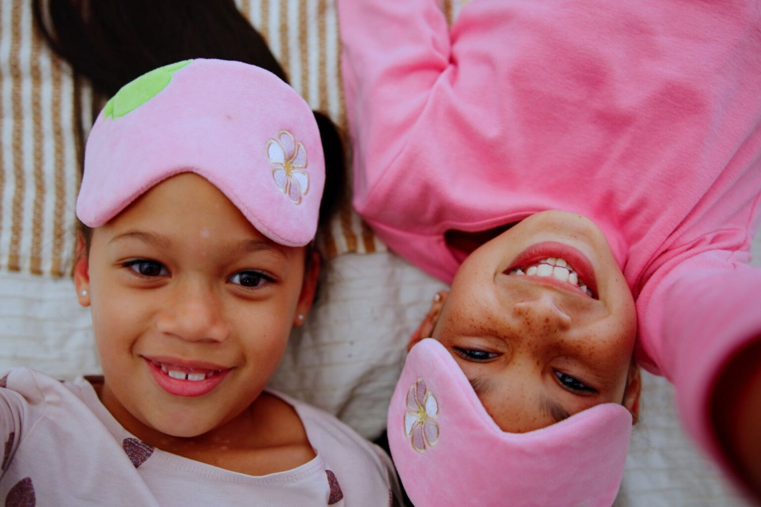 To girls laugh and smile at the camera