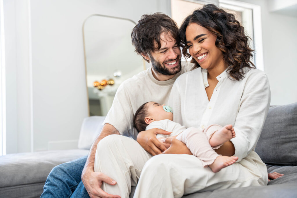 parents bonding with their newborn while reviewing life insurance needs