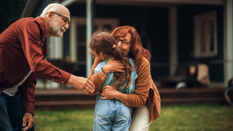 Grandparents hugging grandchild, to illustrate grandparent rights in Canada