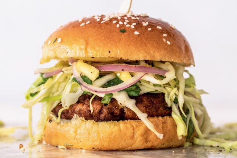 A salmon burger topped with mango slaw