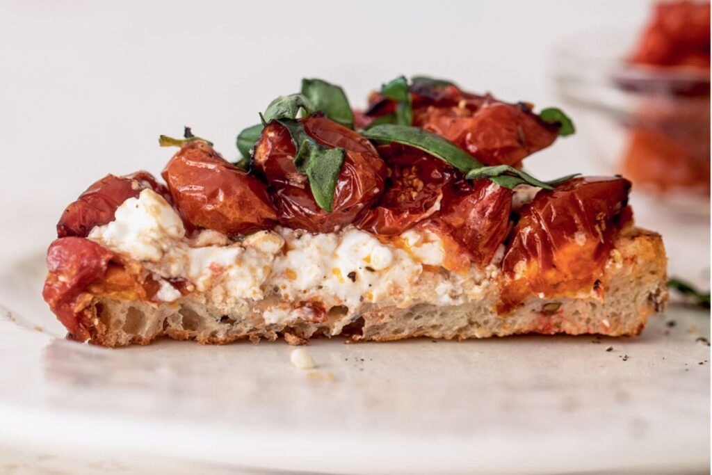 Cottage cheese and burst tomatoes on toast