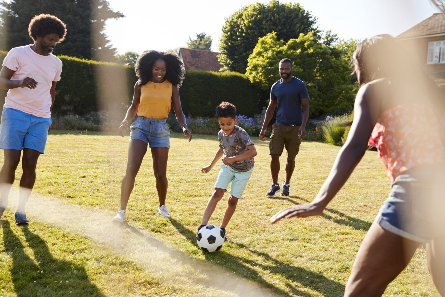 Family prioritizing outdoor time together, playing soccer