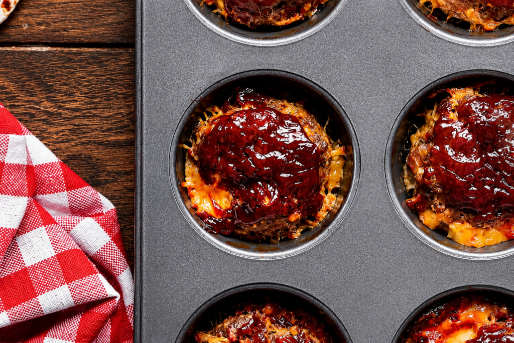 Mini meatloaf muffins with ketchup glaze in a muffin tin