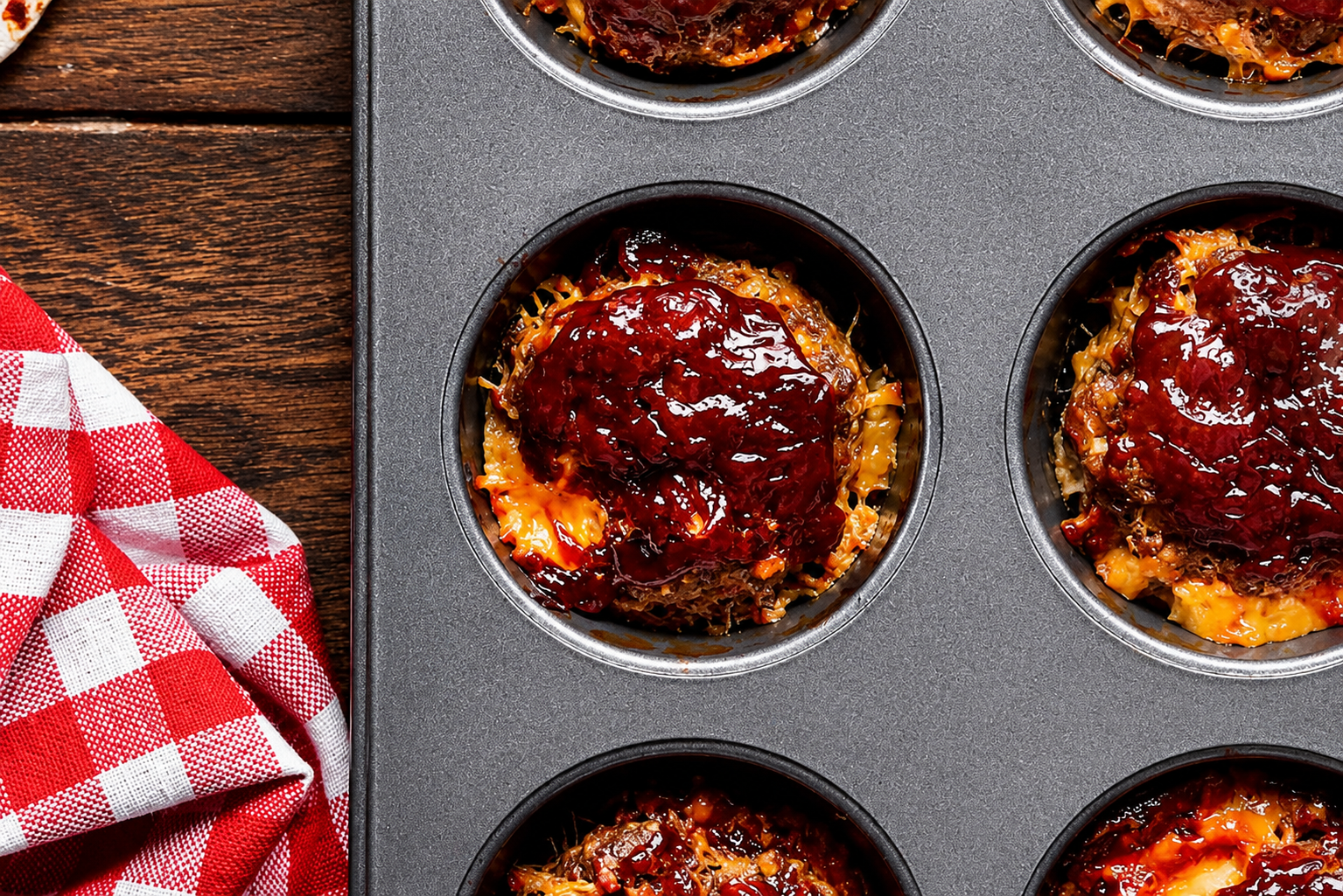Mini meatloaf muffins with ketchup glaze in a muffin tin