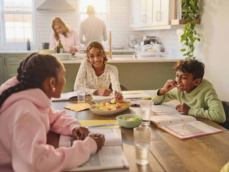 Kids around a table eating a tray of eggs