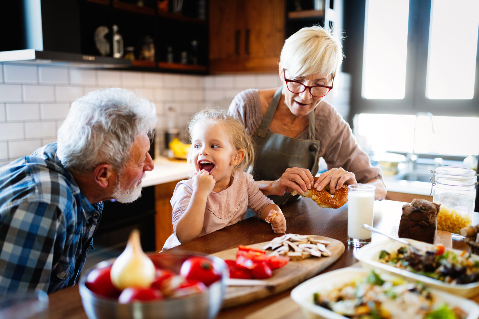Grandparents feeding snacks to hungry grandkid
