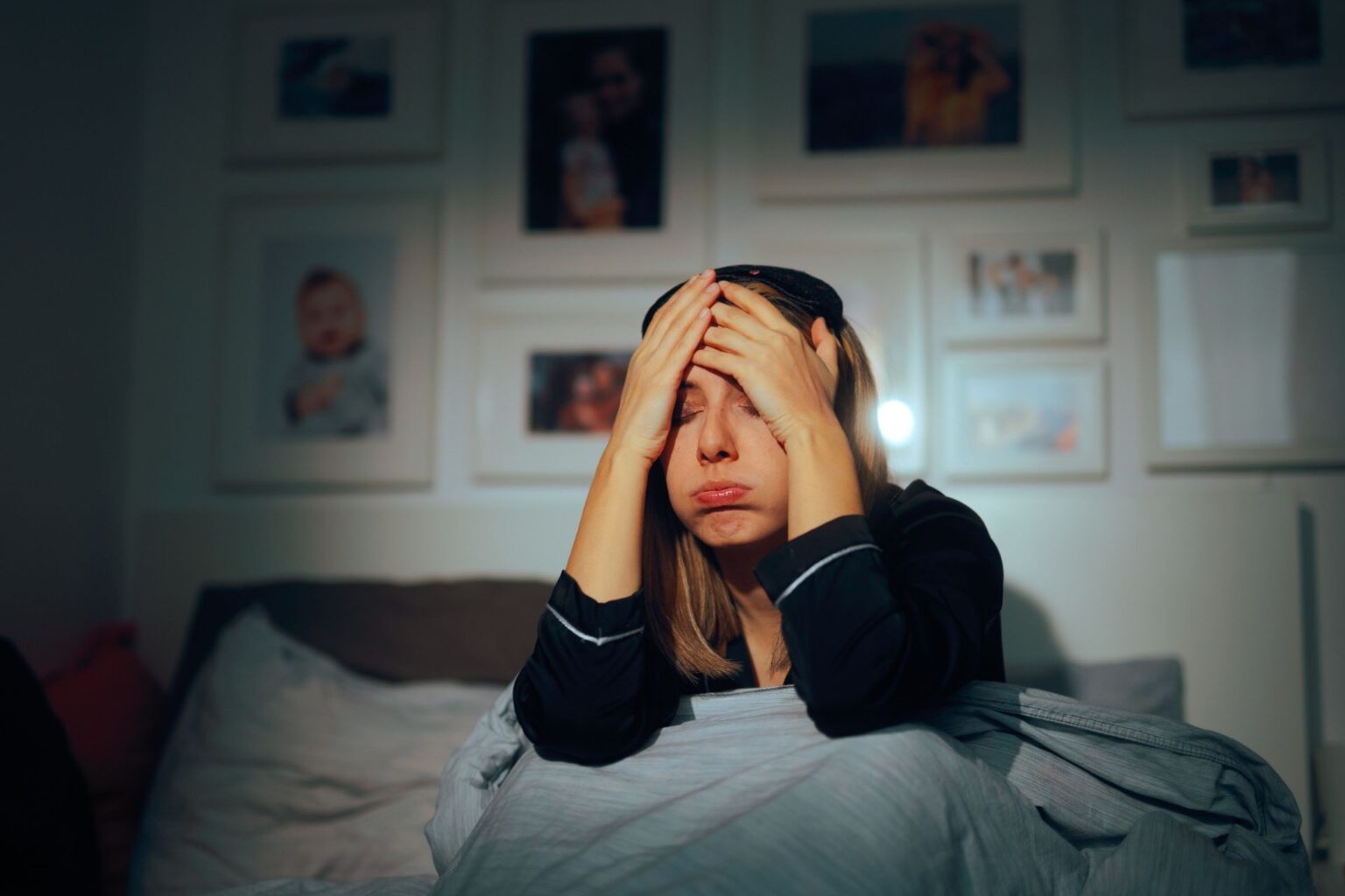 Stressed out parent sitting in bed